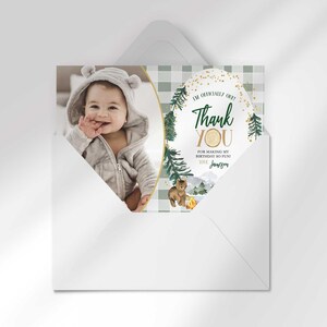 Jameson's camping-themed thank you photo card tucked inside its matching envelope, showing the baby's photo mockup and party thank you message.