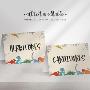 Two folded tent cards with dinosaur illustrations display the words HERBIVORES and CARNIVORES.