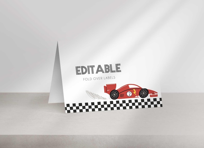 A single white folded tent card on a shelf, showing a black and white checkered border, editable text, and a red race car graphic.