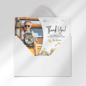 Damian's construction-themed thank you photo card tucked inside its matching envelope, showing the boy's photo mockup and party thank you message.