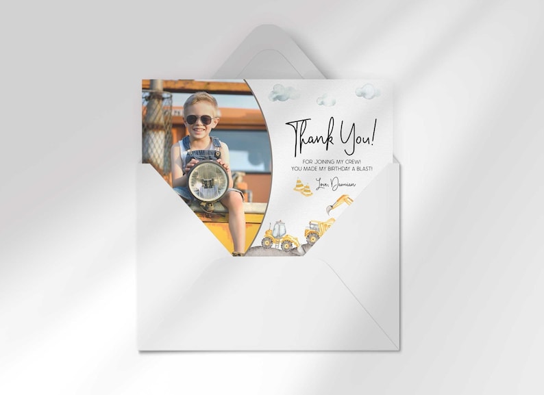 Damian's construction-themed thank you photo card tucked inside its matching envelope, showing the boy's photo mockup and party thank you message.