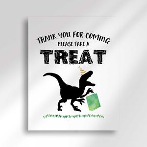 A vertical party sign featuring a black dinosaur silhouette wearing a party hat and holding a green gift bag, with text reading Thank You For Coming Please Take a Treat.