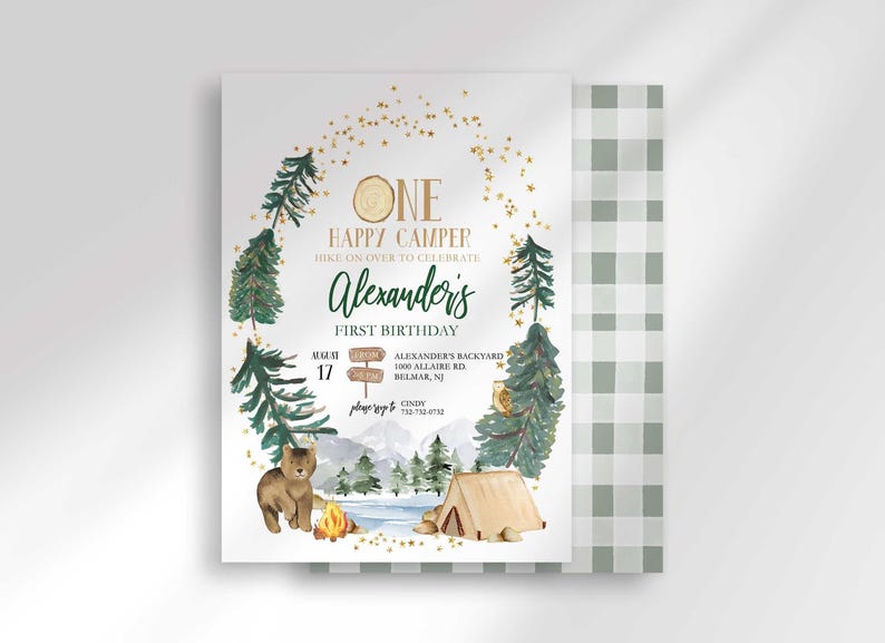 Alexander's camping-themed first birthday invitation with a second card showing a sage green plaid back design peeking out behind it.
