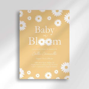 Daisy-themed baby shower invitation in mustard yellow with a white daisy pattern, reading 'Baby in Bloom' for Calla Caravelli, with the party date, time, location, and registry details.