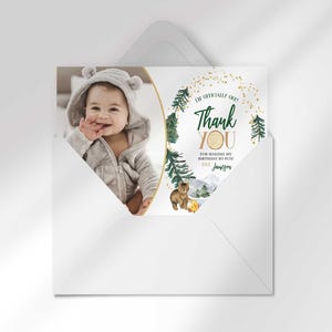 Jameson's camping-themed thank you photo card tucked inside its matching envelope, showing the baby's photo mockup and party thank you message.