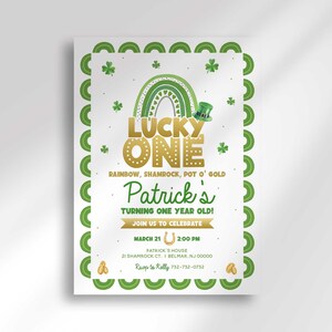 Flat product shot of the Lucky One St. Patrick's Day first birthday invitation, scalloped green shamrock border and gold rainbow illustration, text reading Patrick's Turning One Year Old with party details.