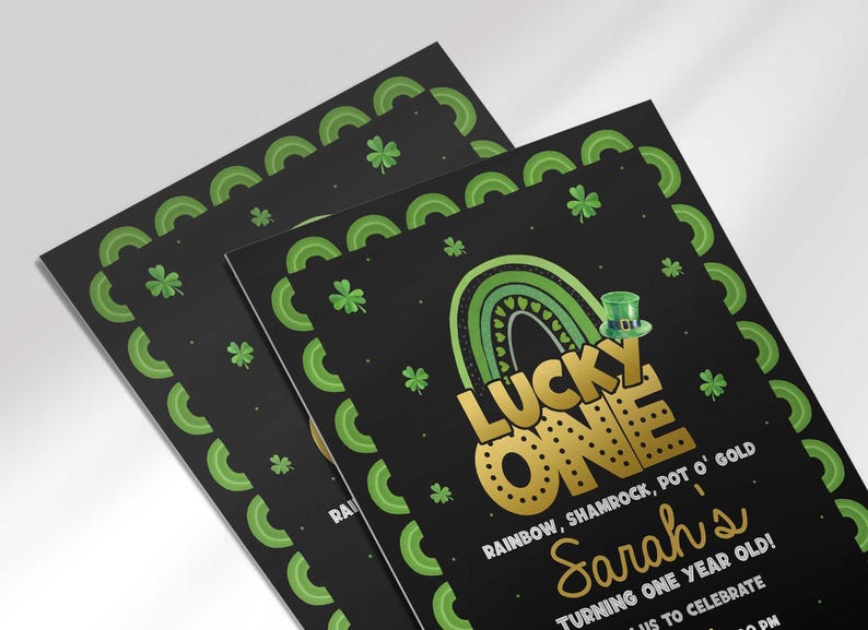 Angled stack of two printed "Lucky One" invitation cards, both showing the same black St. Patrick's Day design for Sarah's first birthday.