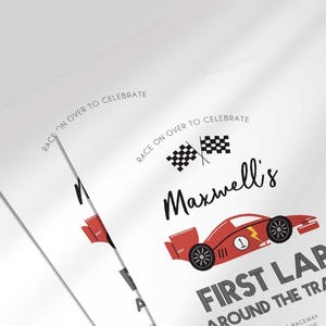Angled close-up of Maxwell's race car-themed first birthday invitation, showing the checkered flags and race car illustration with party details.