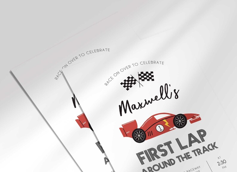 Angled close-up of Maxwell's race car-themed first birthday invitation, showing the checkered flags and race car illustration with party details.