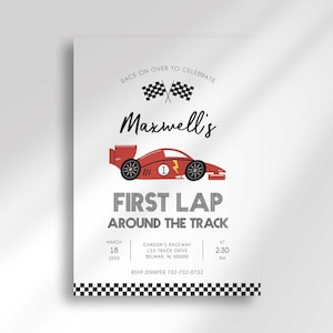Race car-themed first birthday invitation with an illustrated red race car and checkered flags, reading "Race on over to celebrate Maxwell's First Lap Around the Track" with the party date, time, and location, and a checkered flag border along the bottom.
