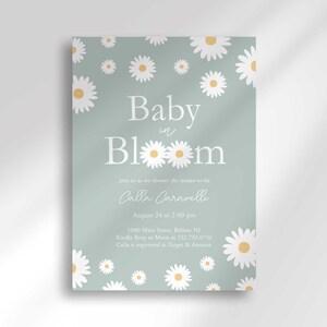 Daisy-themed baby shower invitation in sage green with a white daisy pattern, reading 'Baby in Bloom' for Calla Caravelli, with the party date, time, location, and registry details.