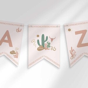 Editable western cactus-themed alphabet and number pennant flag banner strung on twine, with illustrated cacti, cowboy hats, and cow skulls, and an aztec-pattern border.