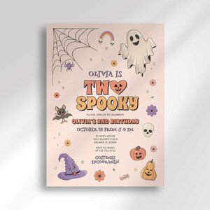 Olivia's Halloween-themed second birthday invitation with a second card showing an orange and cream checkerboard back design peeking out behind it.
