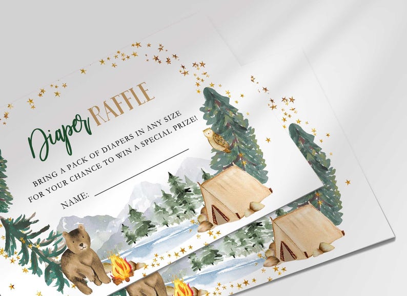 Close-up angled shot of two printed Diaper Raffle cards fanned out, showing the woodland camping design detail up close.