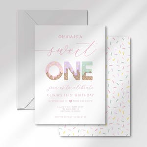 Styled flat lay of the "Sweet ONE" invitation layered on top of a matching envelope, angled to show the sprinkle-pattern side panel.