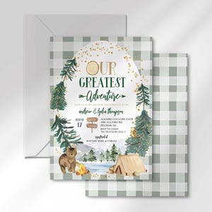 Andrew and Lydia's camping-themed invitation layered in front of its matching envelope and a second card showing the sage green plaid back design.