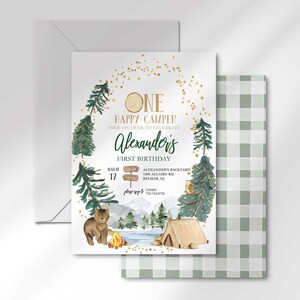 Alexander's camping-themed invitation layered in front of its matching envelope and a second card showing the sage green plaid back design.