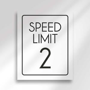 An unframed white rectangular sign displays the text SPEED LIMIT 2 in black.