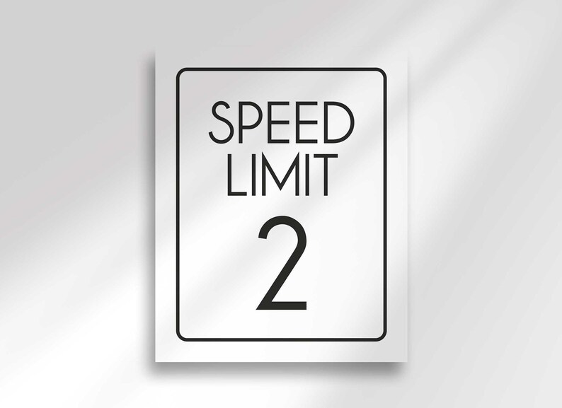 An unframed white rectangular sign displays the text SPEED LIMIT 2 in black.