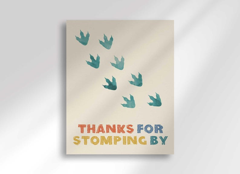 'Thanks for Stomping By' favor sign with a trail of teal dinosaur footprint illustrations.