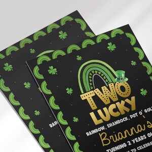 Close-up angled view of the printed Two Lucky birthday invitation showing the shamrock border and gold rainbow design detail.