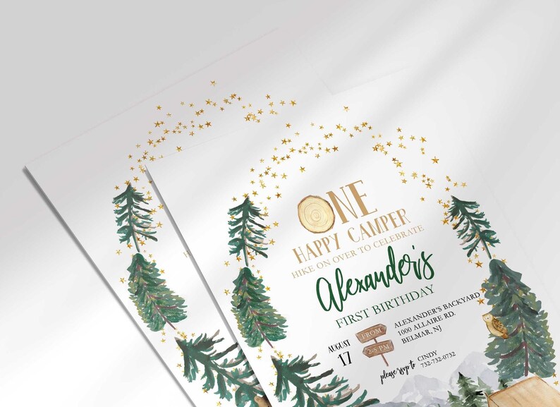 Angled close-up of Alexander's camping-themed first birthday invitation, showing the pine tree and gold star illustrations with party details.