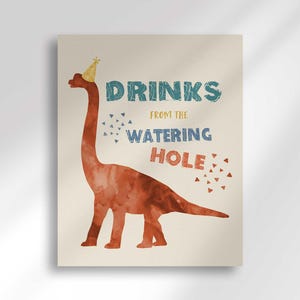 'Drinks From the Watering Hole' beverage station sign featuring a rust-colored brontosaurus illustration wearing a yellow party hat.