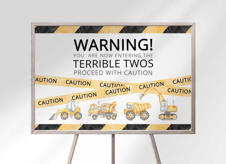 Construction warning tape themed Terrible Twos second birthday welcome sign printed on canvas in a black frame on an easel, with caution tape and construction vehicle illustrations.