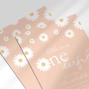 Close-up angled shot of the 'Little Miss ONEderful' daisy-themed invitation for Callie's 1st birthday in blush pink, showing the print quality and daisy pattern detail.