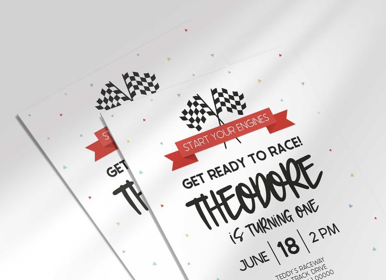 Close-up angled shot of two overlapping printed invitations with scattered confetti, highlighting the checkered flags.