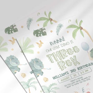 Angled close-up of William's dinosaur-themed third birthday invitation, showing the dinosaur and jungle leaf illustrations with party details.