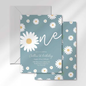 The 'ONE' invitation for Callie's 1st birthday layered in front of its matching envelope and a second card showing the daisy pattern back design.