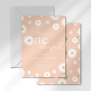 The 'Little Miss ONEderful' invitation for Callie layered in front of its matching envelope and a second card showing the daisy pattern back design.
