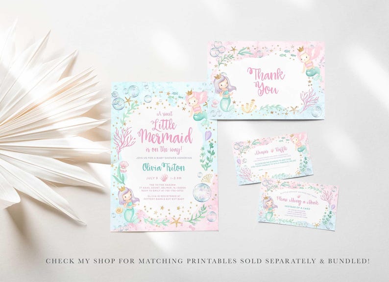 Flat lay of a matching mermaid baby shower stationery suite with a dried palm frond, including the Little Mermaid Is On The Way invitation, a thank you card, a diaper raffle card, and a books and cuddles card, with text noting matching printables are sold separately and bundled in my shop.