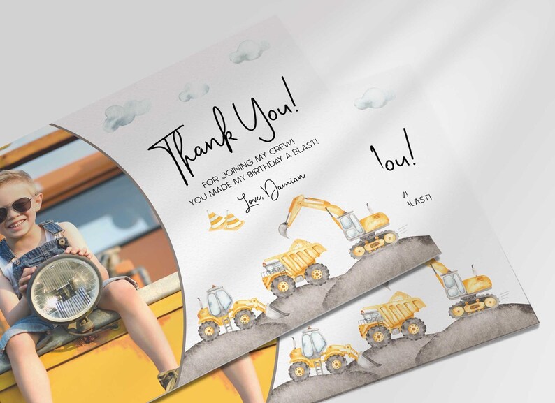 Angled close-up of Damian's construction-themed thank you photo card with the boy's photo mockup, showing the dump truck and excavator illustrations with the thank you message.
