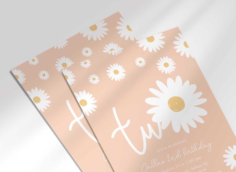 Close-up angled shot of the 'TWO' daisy-themed invitation for Callie's 2nd birthday in pink, showing the print quality and daisy pattern detail.