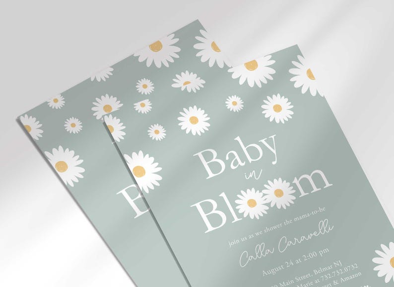 Close-up angled shot of the 'Baby in Bloom' daisy-themed invitation for Calla Caravelli in sage green, showing the print quality and daisy pattern detail.