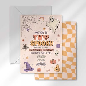 Olivia's Halloween-themed second birthday invitation layered in front of its matching envelope and a second card showing an orange checkerboard back design.
