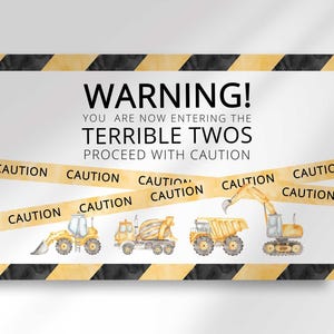 Flat print preview of the Warning Terrible Twos construction caution tape themed second birthday welcome sign with construction vehicle illustrations.