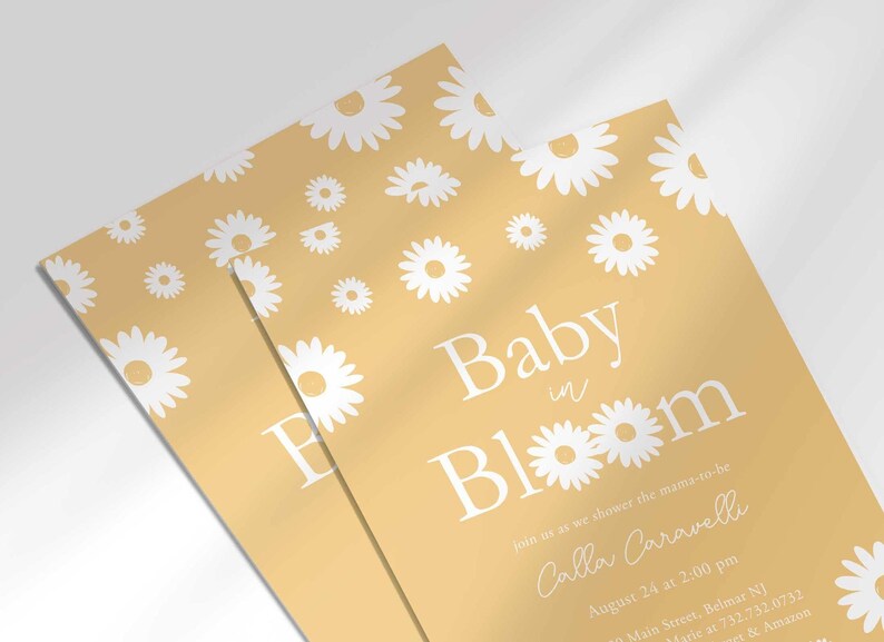 Close-up angled stack of two prints of the 'Baby in Bloom' daisy-themed invitation for Calla Caravelli, showing the print quality and daisy pattern detail.