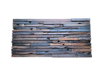 May include: A rectangular wall panel made of reclaimed wood planks. The planks are arranged horizontally, showcasing a mix of brown, gray, and blue tones. The wood has a weathered appearance with visible knots and imperfections, adding to its rustic charm.