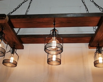 May include: A rustic wooden chandelier with six caged light bulbs. The chandelier is made of reclaimed wood and has a farmhouse style.