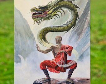 May include: An acrylic painting depicts a bald figure in a red robe in a martial arts stance, with a green dragon above. The dragon curves around the figure against a backdrop of mountains and a waterfall. The artwork is signed in the lower right corner.