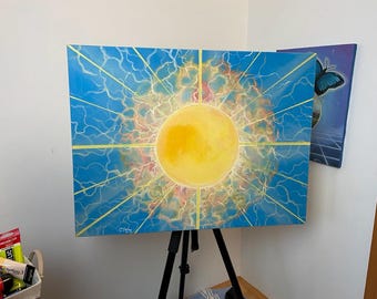 May include: A vibrant abstract painting of a yellow sunburst against a blue sky, with radiating lines and lightning-like patterns. The artwork is displayed on a black easel, showcasing a bold and energetic design.