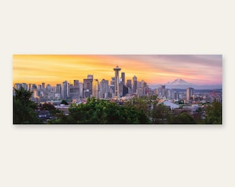 May include: A panoramic view of the Seattle skyline at sunset, featuring the Space Needle prominently among numerous skyscrapers, with lush green trees in the foreground and a snow-capped mountain visible in the distance under a golden sky.
