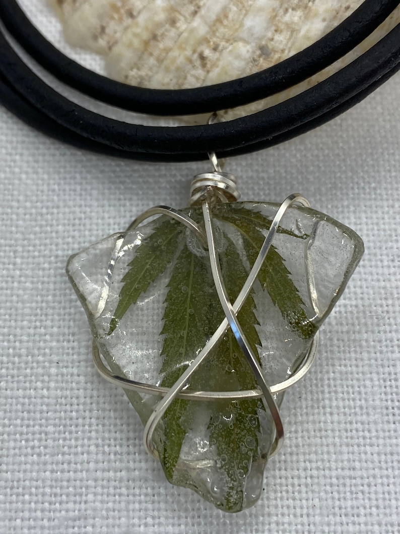 Handmade cannabis necklaces preserved on sea glass and coated in resin