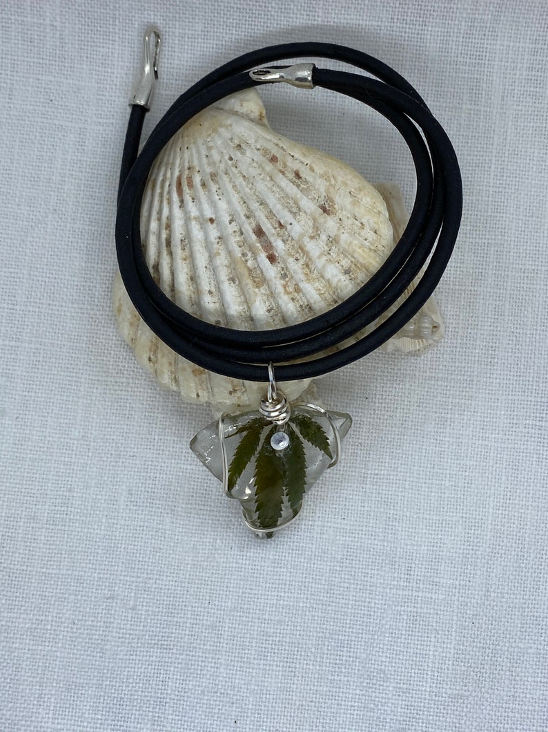 Handmade cannabis necklaces preserved on sea glass and coated in resin