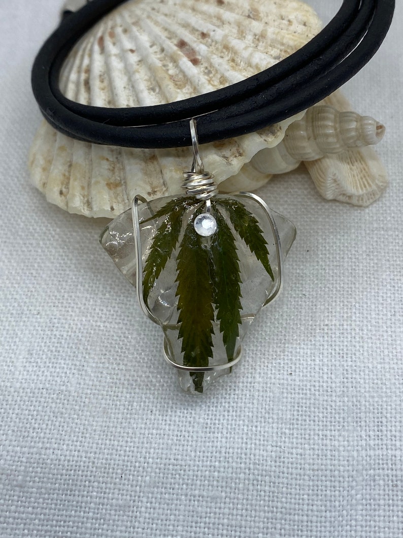 Handmade cannabis necklaces preserved on sea glass and coated in resin