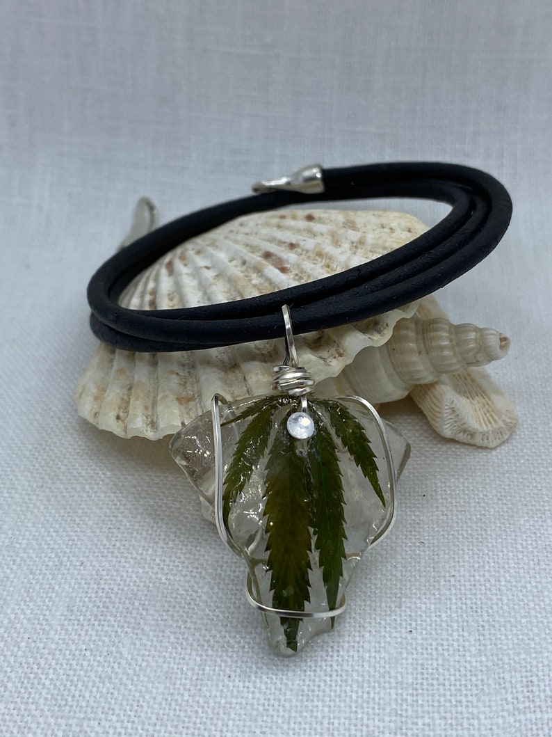 Handmade cannabis necklaces preserved on sea glass and coated in resin