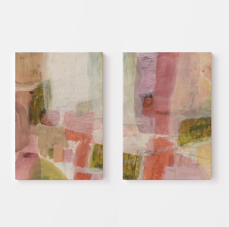 May include: A set of two rectangular wall art canvases featuring abstract compositions. The paintings display layered brushstrokes in muted shades of dusty rose, soft peach, olive green, and cream, with thin graphite lines intersecting the color blocks.